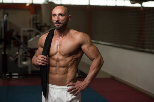 Sexy Muscular Man With Black Belt On Shoulder