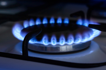 The blue flame from the burner of a gas stove
