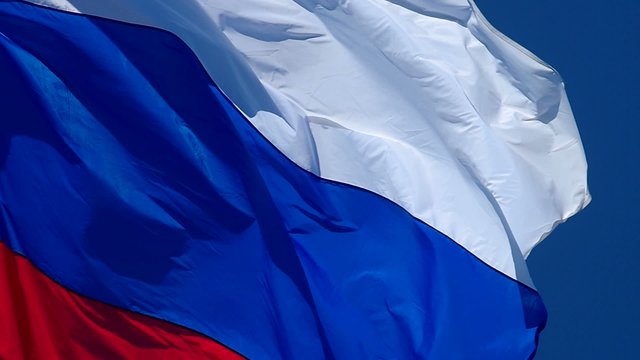 Russian flag, growing in the wind