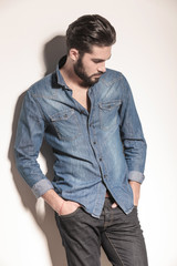 side view of a sad casual man looking down