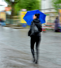 Woman walking in the street on a rainy day