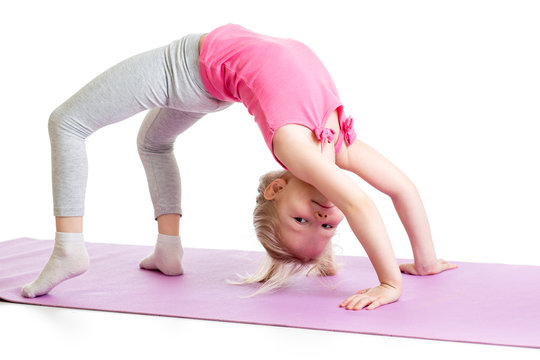 kid girl doing gymnastics on fitness mat