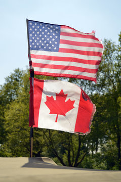 National flags of USA and Canada on one flagstaff