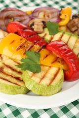 Delicious grilled vegetables on plate on table close-up