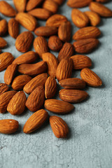 Almonds on color wooden background