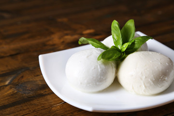 Tasty mozzarella cheese with basil