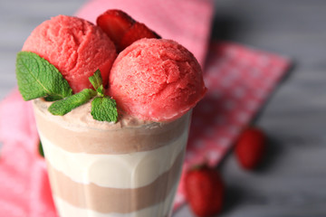 Tasty chocolate mousse with sorbet on wooden table