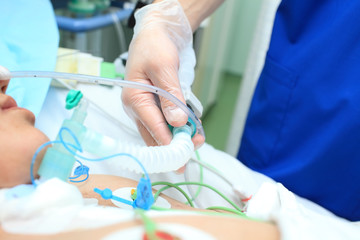 Typical work of nurse the ICU. Patient in hospital bed