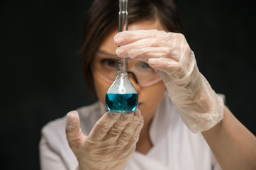 Female scientific researcher holding glass test-tube
