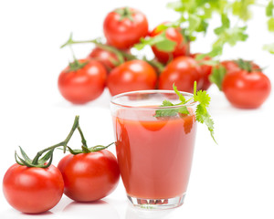Glass of fresh tomato juice and tomatoes