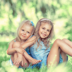Two little cute girls on lawn in the park © Milles Studio