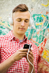 Fototapeta premium Happy handsome man enjoying his music