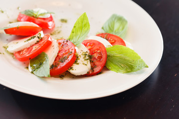Tomato and mozzarella with basil leaves