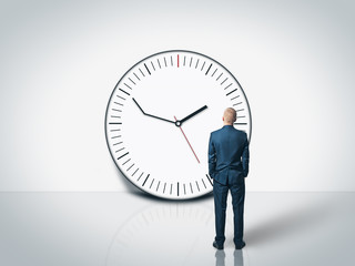 man looking at the delay clock on the wall