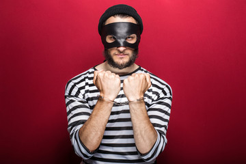 Angry thief with handcuffs