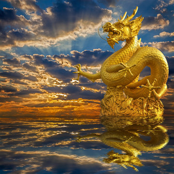 Chinese Golden Dragon Statue with sunset