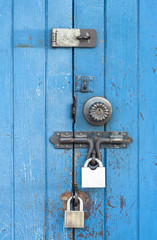 Blue wooden door with security lock.