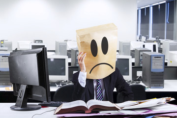 Exhausted businessman with cardboard head
