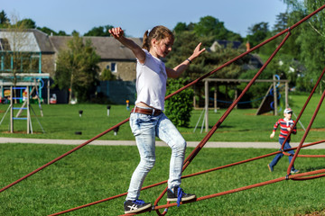 Teenage girl playing on child playground