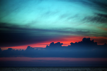 Multicolor sunset sky with clouds on lake