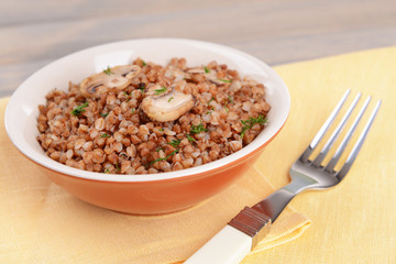 Boiled buckwheat in bowl on table close-up
