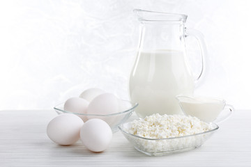 Tasty dairy products on wooden table