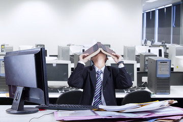 Stressful businessman covering his face