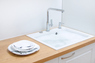 Clean dishes near the sink in the kitchen.