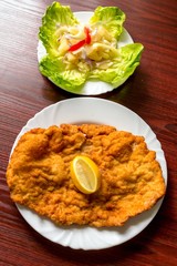 Wiener schnitzel with salad closeup