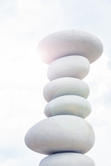 balancing stones against blue sky