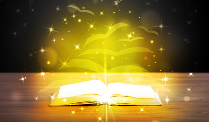 Open book with golden glow flying paper pages