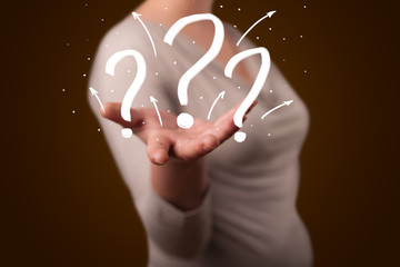Young woman presenting hand drawn question marks