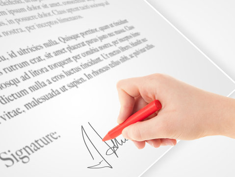 Hand writing personal signature on a paper form