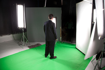Male fashion model standing in a film studio