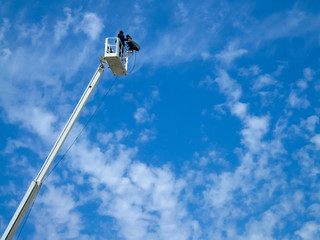 Low angle view of cameraman filming on a crane