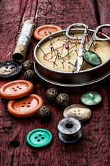 buttons and zipper on the background of sewing tool