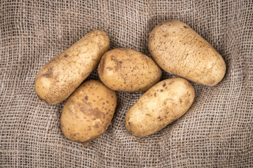 Potatoes on burlap sack.