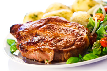 Grilled steak, boiled potatoes and vegetable salad