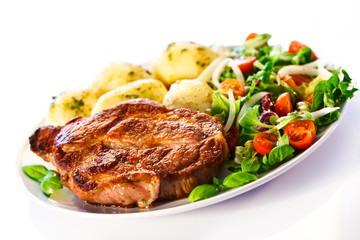 Grilled steak, boiled potatoes and vegetable salad