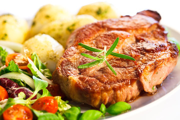 Grilled steak, boiled potatoes and vegetable salad