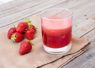 Fresh strawberry smoothie juice and strawberries