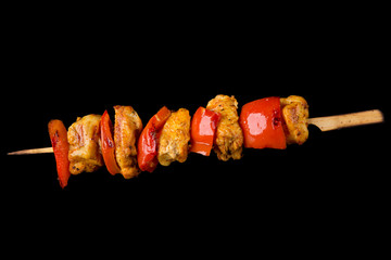 Tasty skewers on black background.