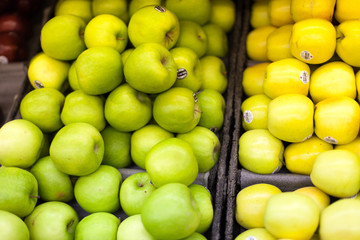 Granny smith and golden apples for sale in a supermarket