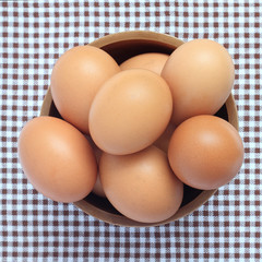 wood bowl with brown eggs