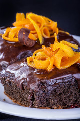 Delicious and sweet chocolate cake decorated with orange