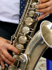 Fototapeta premium fragment of tenor saxophone with hands of musician