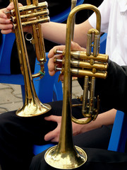 trumpets on the knees of resting musicians