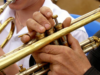 fragment of trumpet with hands of musician