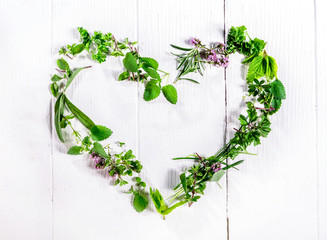 Heart shaped frame of fresh culinary herbs