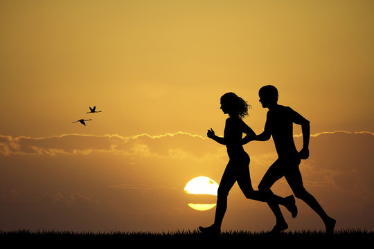 Girl and boy running at sunset